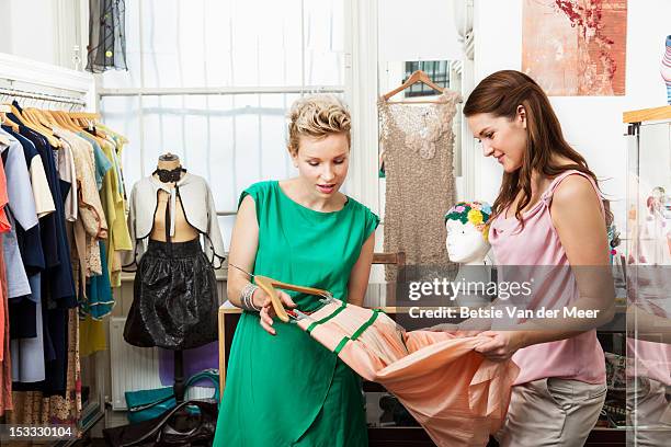 fashion designer shows client skirt. - designer shopping stock pictures, royalty-free photos & images