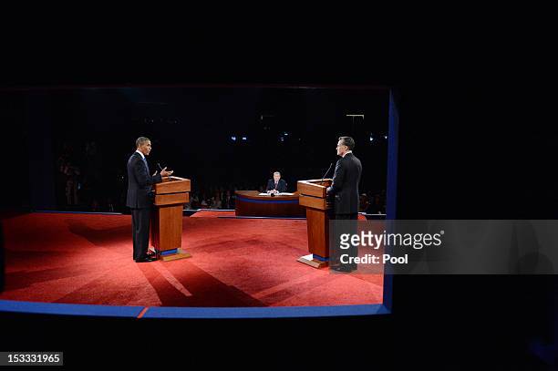 President Barack Obama speaks as Republican presidential candidate and former Massachusetts Gov. Mitt Romney listens during the Presidential Debate...