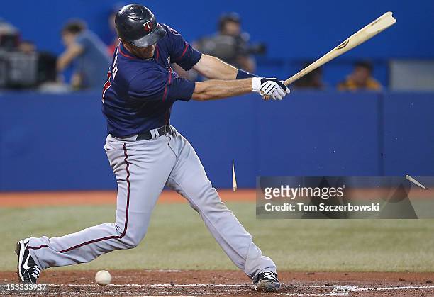 Drew Butera of the Minnesota Twins splinters his bat in the third inning on a foul tip during MLB game action against the Toronto Blue Jays on...