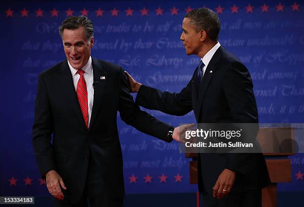 Democratic presidential candidate, U.S. President Barack Obama and Republican presidential candidate, former Massachusetts Gov. Mitt Romney smile...