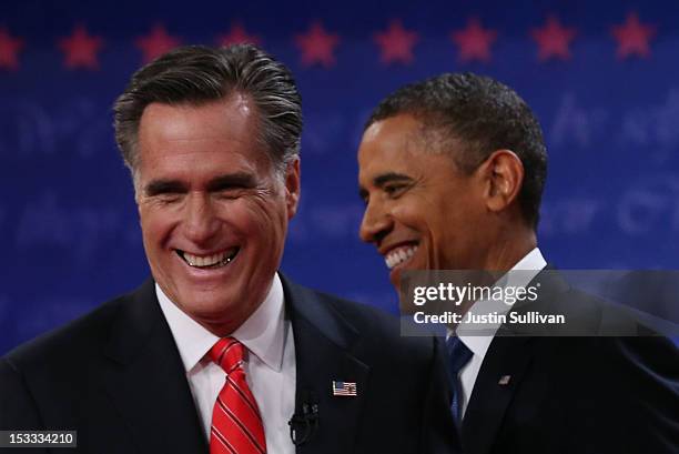 Democratic presidential candidate, U.S. President Barack Obama and Republican presidential candidate, former Massachusetts Gov. Mitt Romney smile...