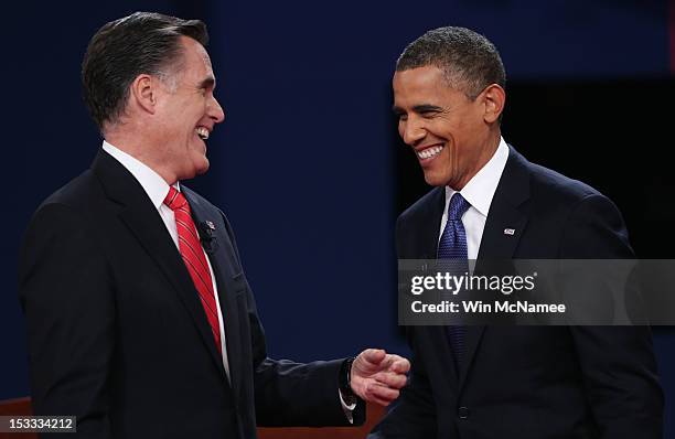 Democratic presidential candidate, U.S. President Barack Obama and Republican presidential candidate, former Massachusetts Gov. Mitt Romney smile...