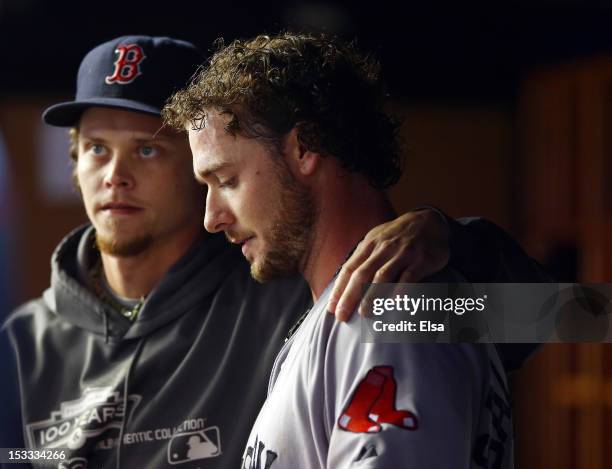 Jarrod Saltalamacchia of the Boston Red Sox is consoled by teammate Clay Buchholz after the loss to the New York Yankees on October 3, 2012 at Yankee...