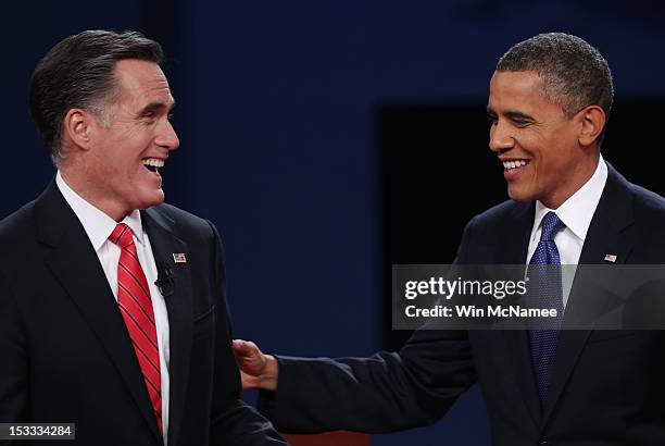 Democratic presidential candidate, U.S. President Barack Obama and Republican presidential candidate, former Massachusetts Gov. Mitt Romney smile...