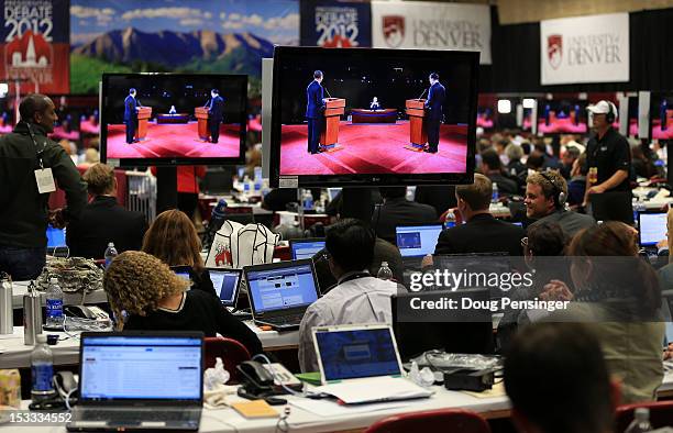 Reporters watch the final minutes of the Presidential Debate between Democratic presidential candidate, U.S. President Barack Obama and Republican...