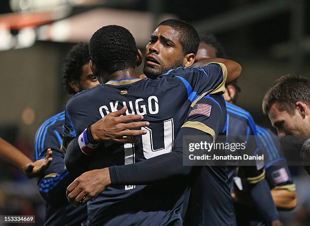 Gabriel Gomez of the Philadelphia Union gets a hug from Amobi Okugo after scoring a second half goal against the Chicago Fire during an MLS match at...