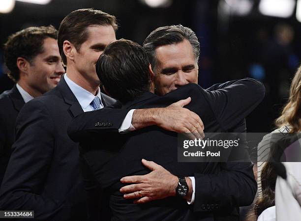 Republican presidential candidate and former Massachusetts Gov. Mitt Romney hugs Tagg Romney as Josh Romney and Craig Romney look on at the end of...