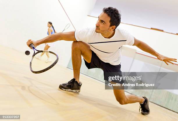 hispanic couple playing squash - squash racquet fotografías e imágenes de stock