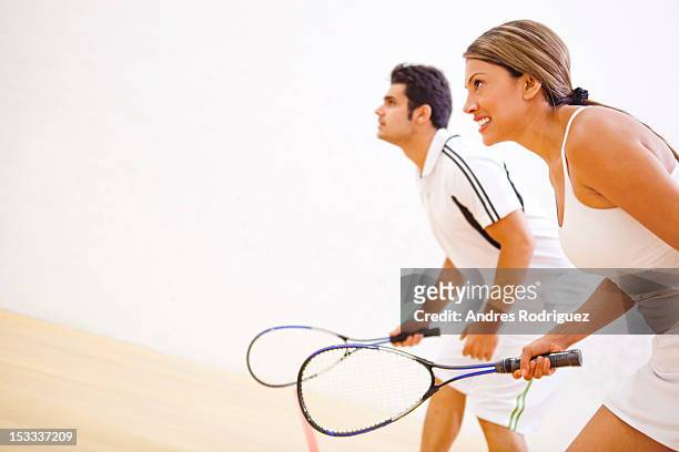 hispanic couple playing squash - squash game stock pictures, royalty-free photos & images