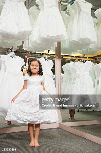 mixed race girl trying on white dress - comunhão imagens e fotografias de stock