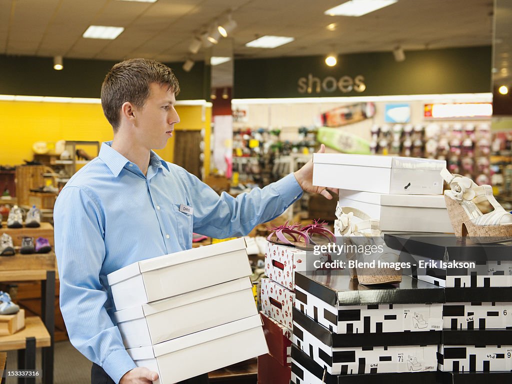 Caucasian man working in shoe store