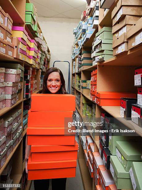 caucasian woman holding shoes in stockroom - price utah bildbanksfoton och bilder