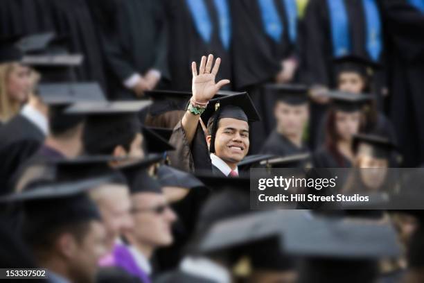 college graduate waving - graduation crowd stock pictures, royalty-free photos & images