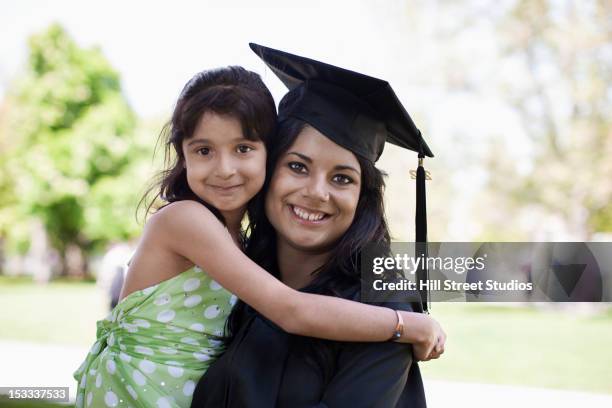 daughter hugging college graduate mother - indian sibling stock pictures, royalty-free photos & images