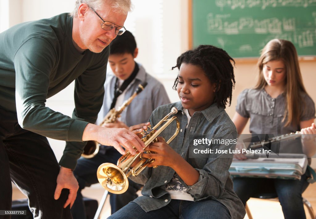 Students preparing to play musical instruments