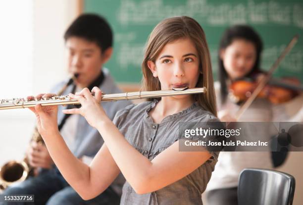 students playing musical instruments - flute musical instrument stock pictures, royalty-free photos & images