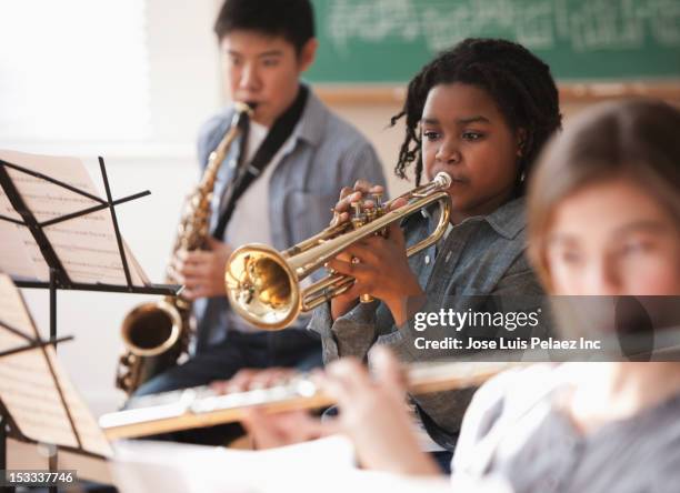 students playing musical instruments - music instrument stock-fotos und bilder