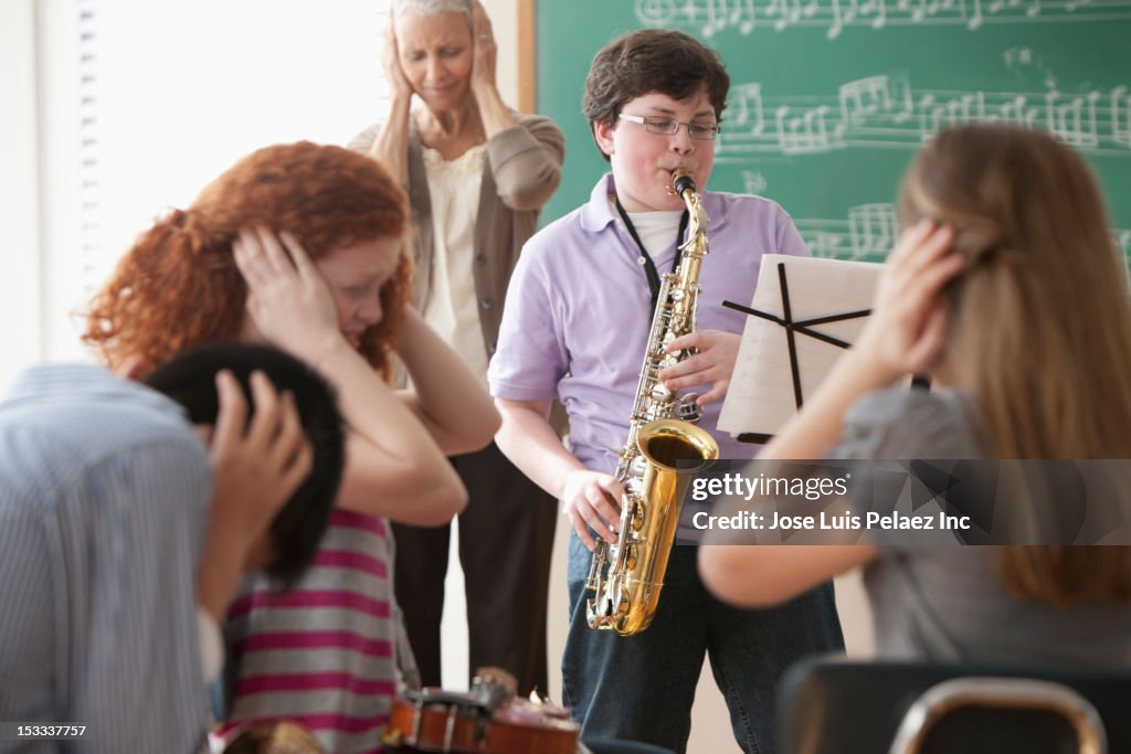 Student playing saxophone badly