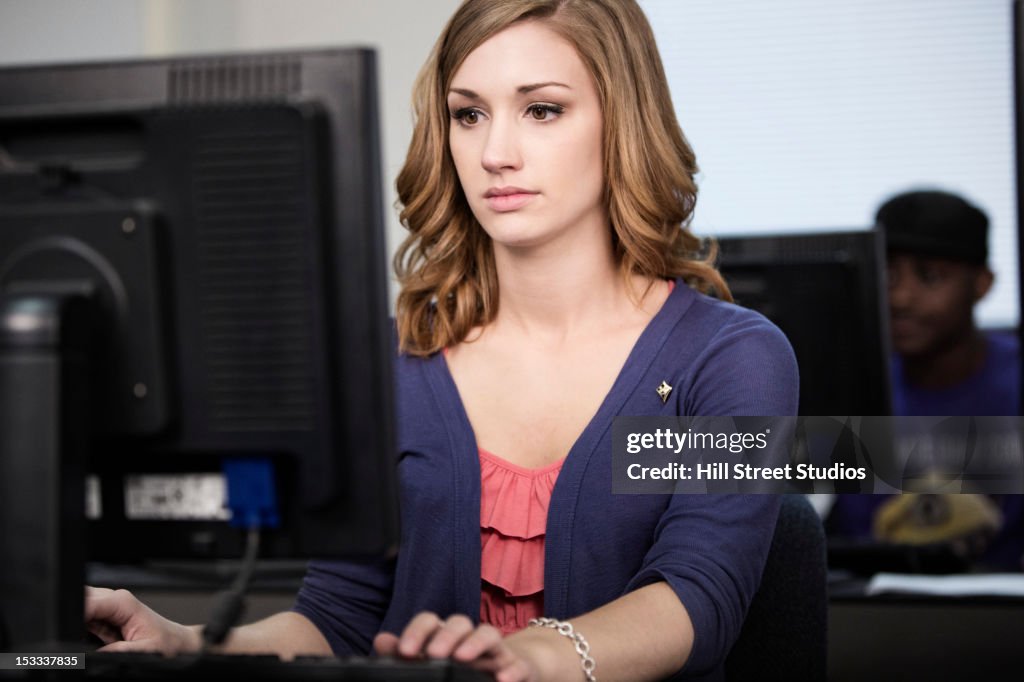 Caucasian woman studying in computer lab