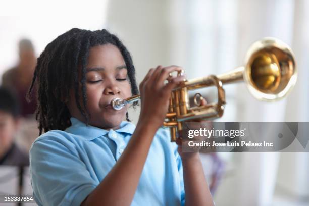 black student playing trumpet in music class - tromba foto e immagini stock
