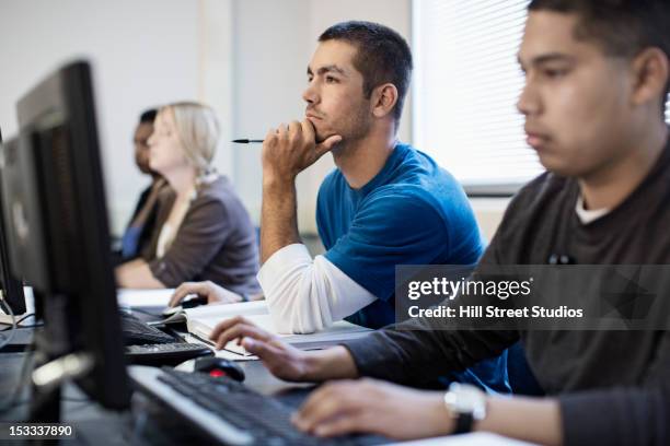 students studying in computer lab - head in hands computer stock pictures, royalty-free photos & images