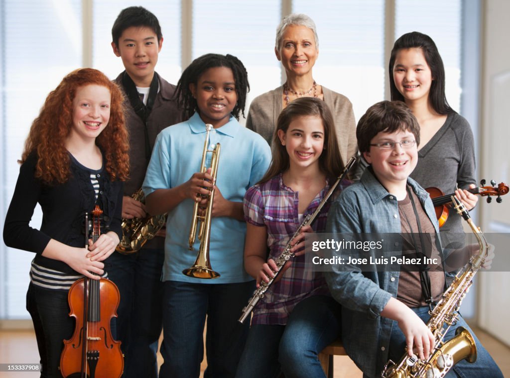 Students Using Instruments Teacher And Students Holding Musical Instruments High-Res Stock Photo ...