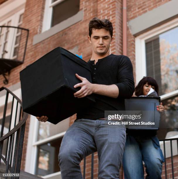 friends carrying bins downstairs - summer university day 2 foto e immagini stock