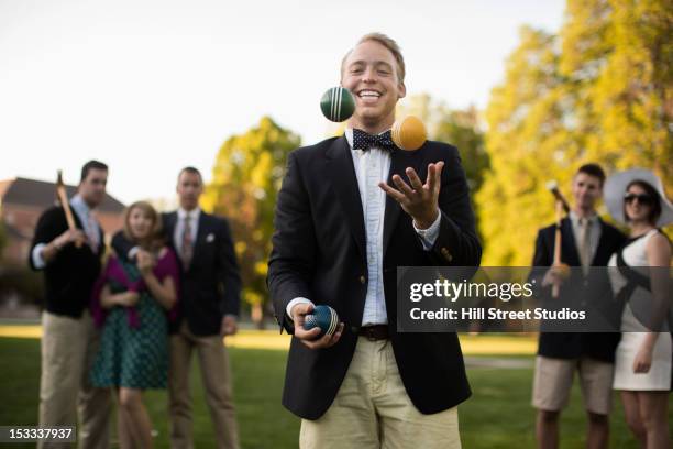 caucasian man juggling croquet balls - smart casual stock pictures, royalty-free photos & images