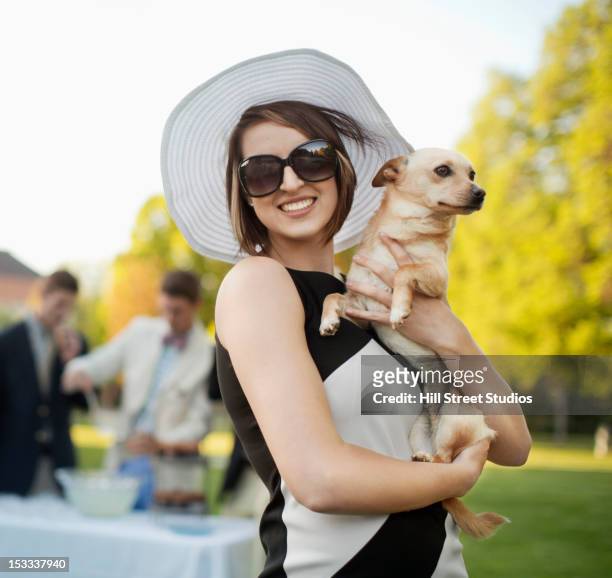 elegant caucasian woman holding small dog - upper class stock pictures, royalty-free photos & images
