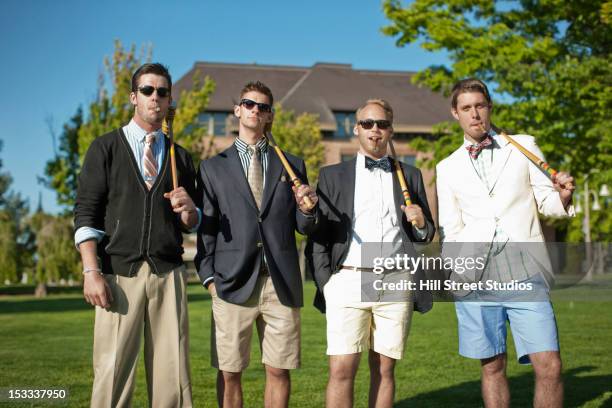 caucasian man standing together with croquet mallets - b��ro stock-fotos und bilder