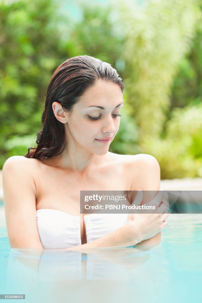 Caucasian woman enjoying swimming pool