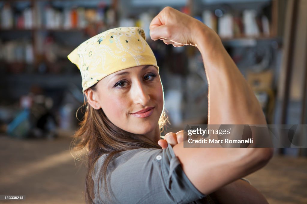 Hispanic worker flexing biceps