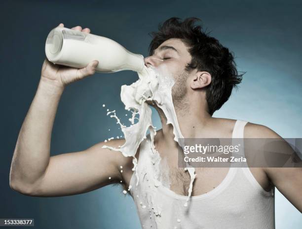 caucasian man drinking milk and spilling it - törstig bildbanksfoton och bilder