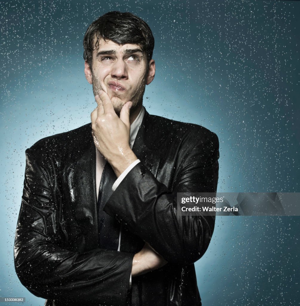 Caucasian businessman caught in the rain