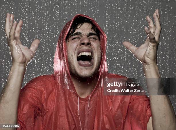 caucasian man caught in the rain - raincoat ストックフォトと画像