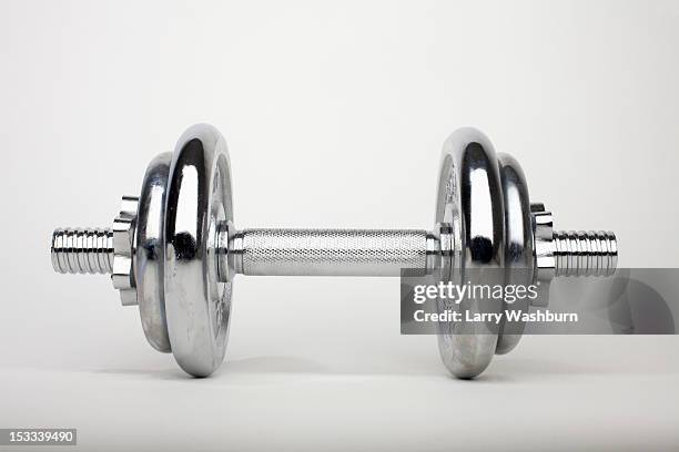 a shiny silver dumbbell - dumbells stock-fotos und bilder