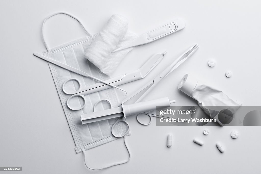 Medicine and medical equipment painted white and scattered on a white surface