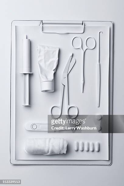 medicine and medical equipment painted white and laid out on a clipboard - knolling tools stock pictures, royalty-free photos & images