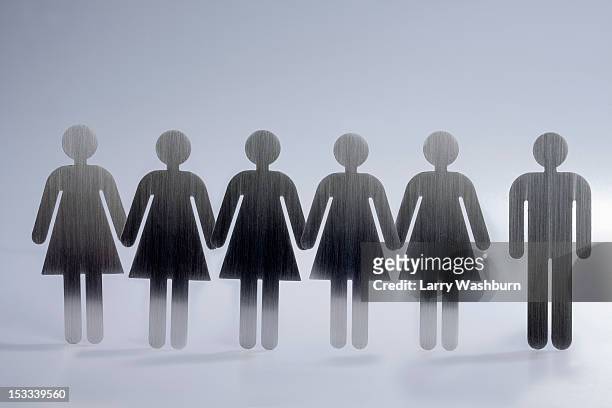 five female restroom sign figures in a row and one male restroom sign figure - polygamie stockfoto's en -beelden