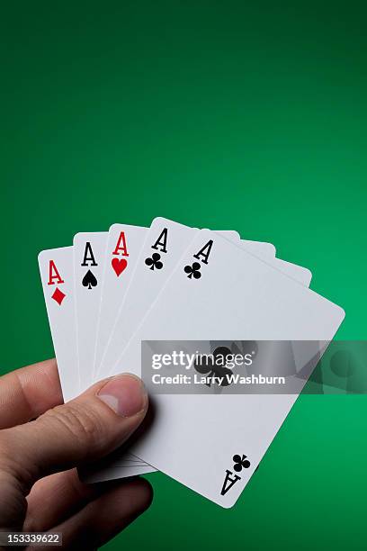 a hand holding five aces fanned out - hand of cards stock pictures, royalty-free photos & images