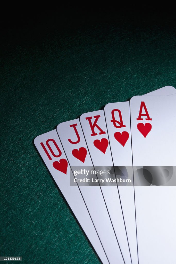 A straight flush fanned out on a table