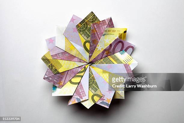 european union currency folded into a pinwheel shape - all european currencies stock pictures, royalty-free photos & images