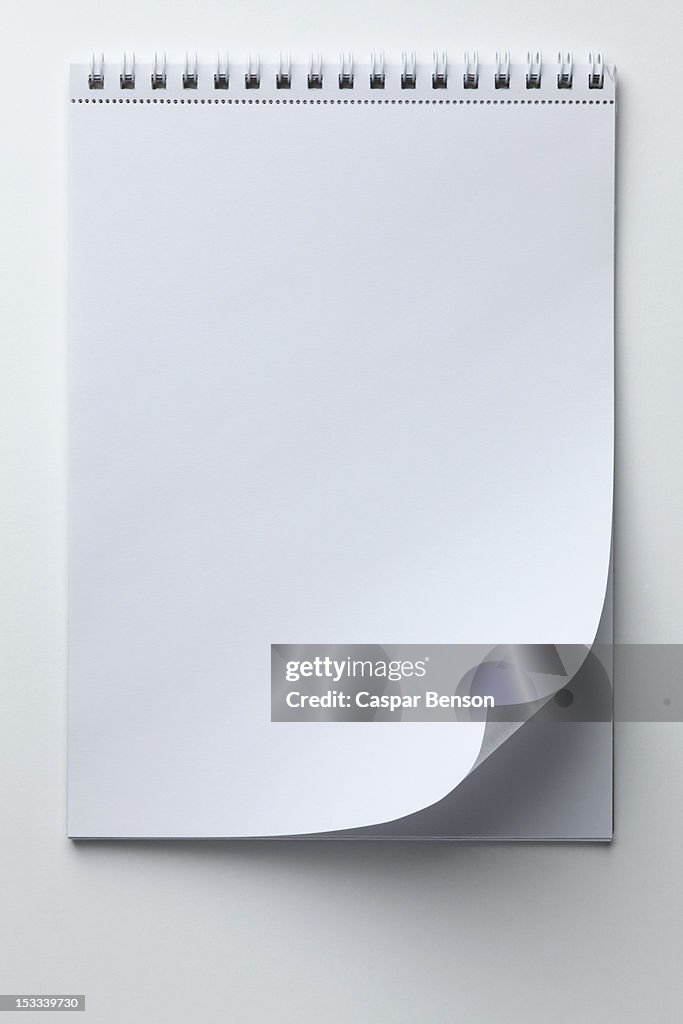 A blank sketch pad with curled up page corner