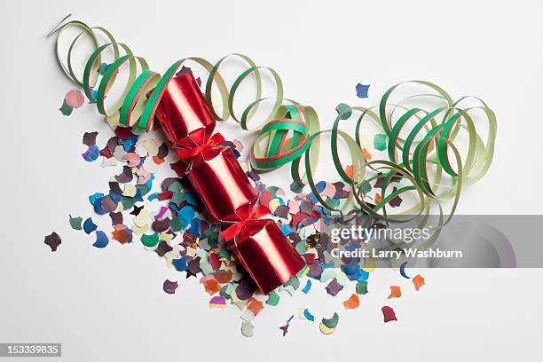 confetti, streamers and a christmas cracker - christmas crackers stock pictures, royalty-free photos & images