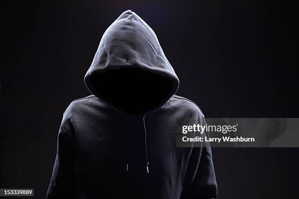 hidden man in hooded top - kapuze stock-fotos und bilder
