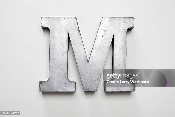 metal letter m - capital letter stock-fotos und bilder