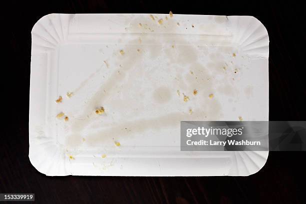 greasy stain from pizza slice on paper plate - greasy paper plate stock pictures, royalty-free photos & images