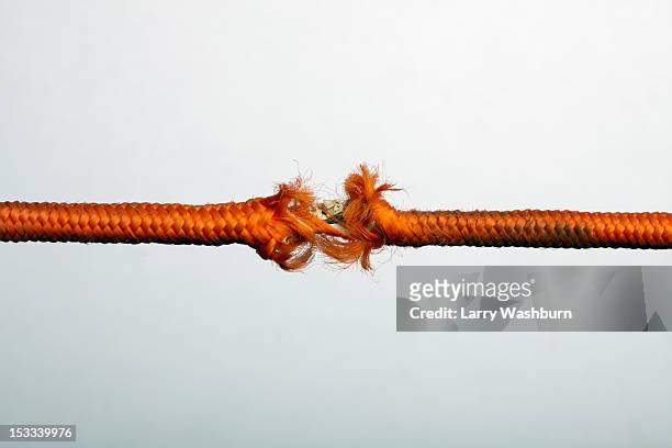 a fraying orange rope - 綱引き ストックフォトと画像