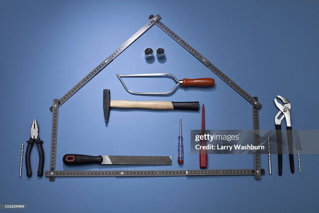 A Folding Ruler Arranged To Look Like A House With Various Work Tools ...