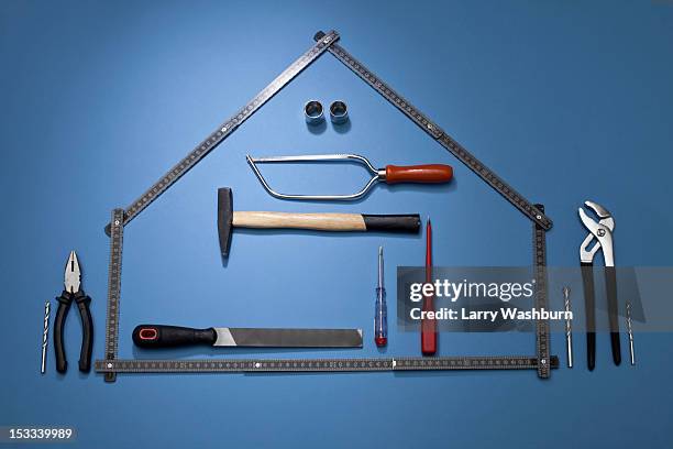 a folding ruler arranged to look like a house with various work tools - house rules stock pictures, royalty-free photos & images